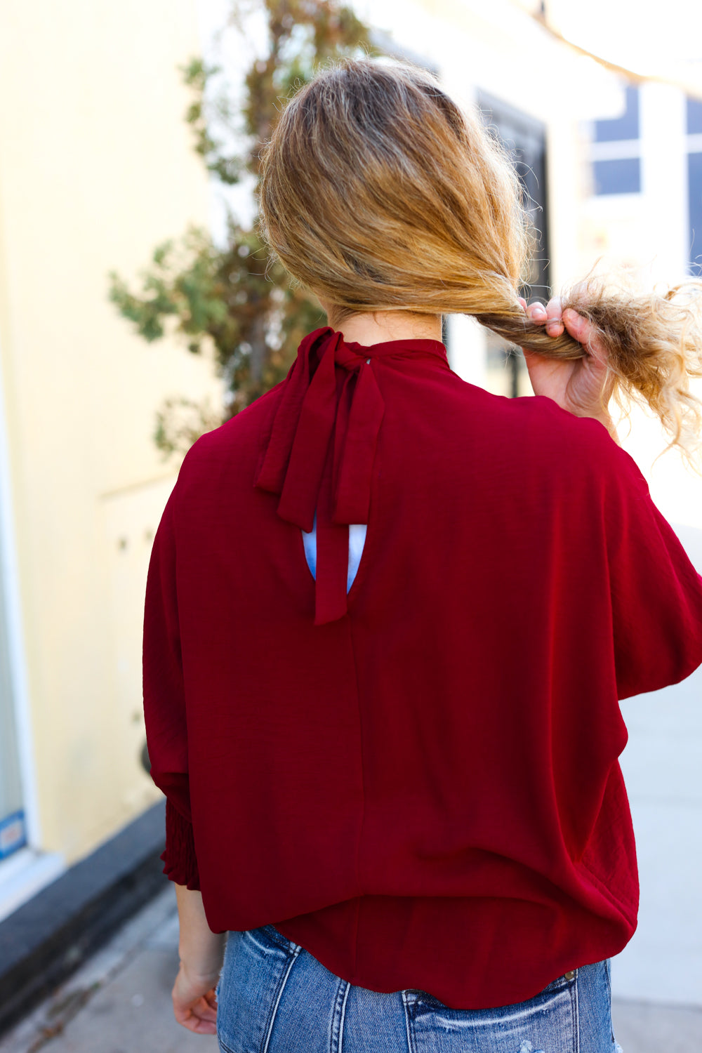 Bold Dreams Wine Smocked Three Quarter Sleeve Tie Back Top - Charming Charlie
