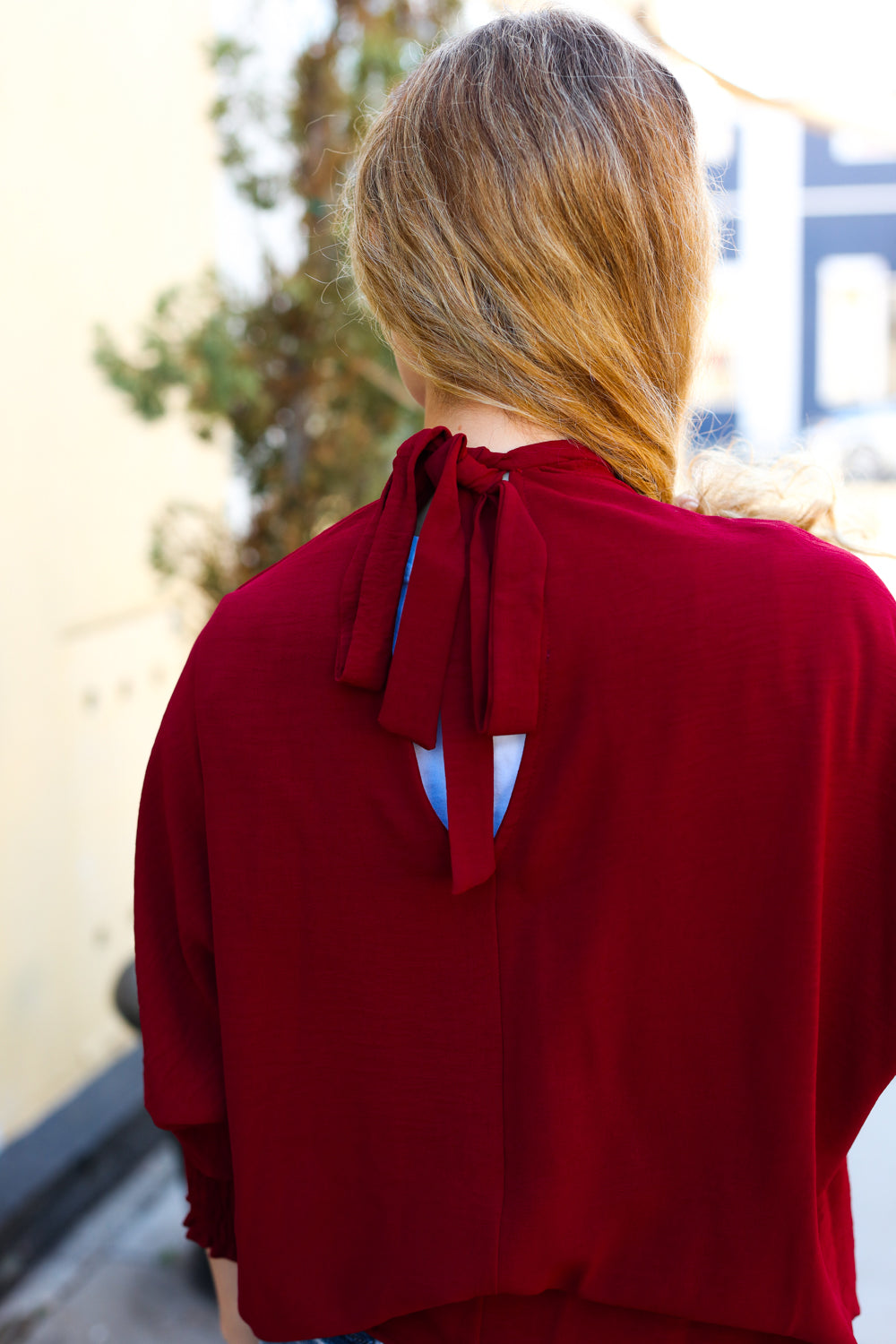 Bold Dreams Wine Smocked Three Quarter Sleeve Tie Back Top - Charming Charlie
