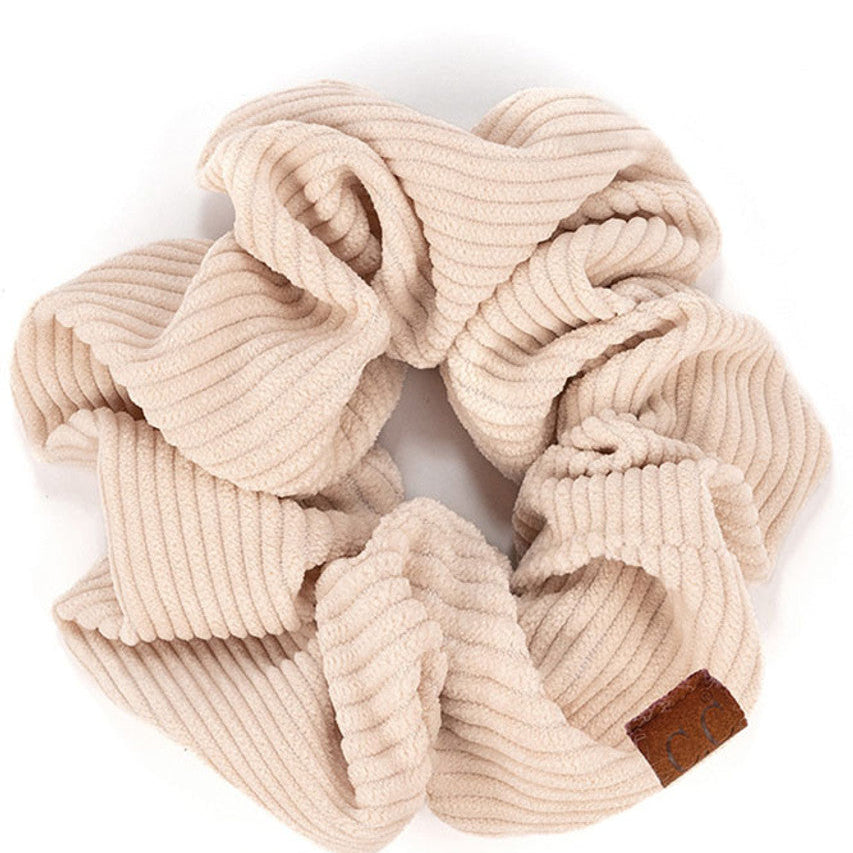 Beige C.C Corduroy Solid Color Soft Scrunchies are a must-have for any hair accessory collection. Made from soft and durable corduroy material, these scrunchies are perfect for any hair type and can hold hair in place comfortably without causing any damage. Add some style to your hairstyle with these versatile and fashionable scrunchies.