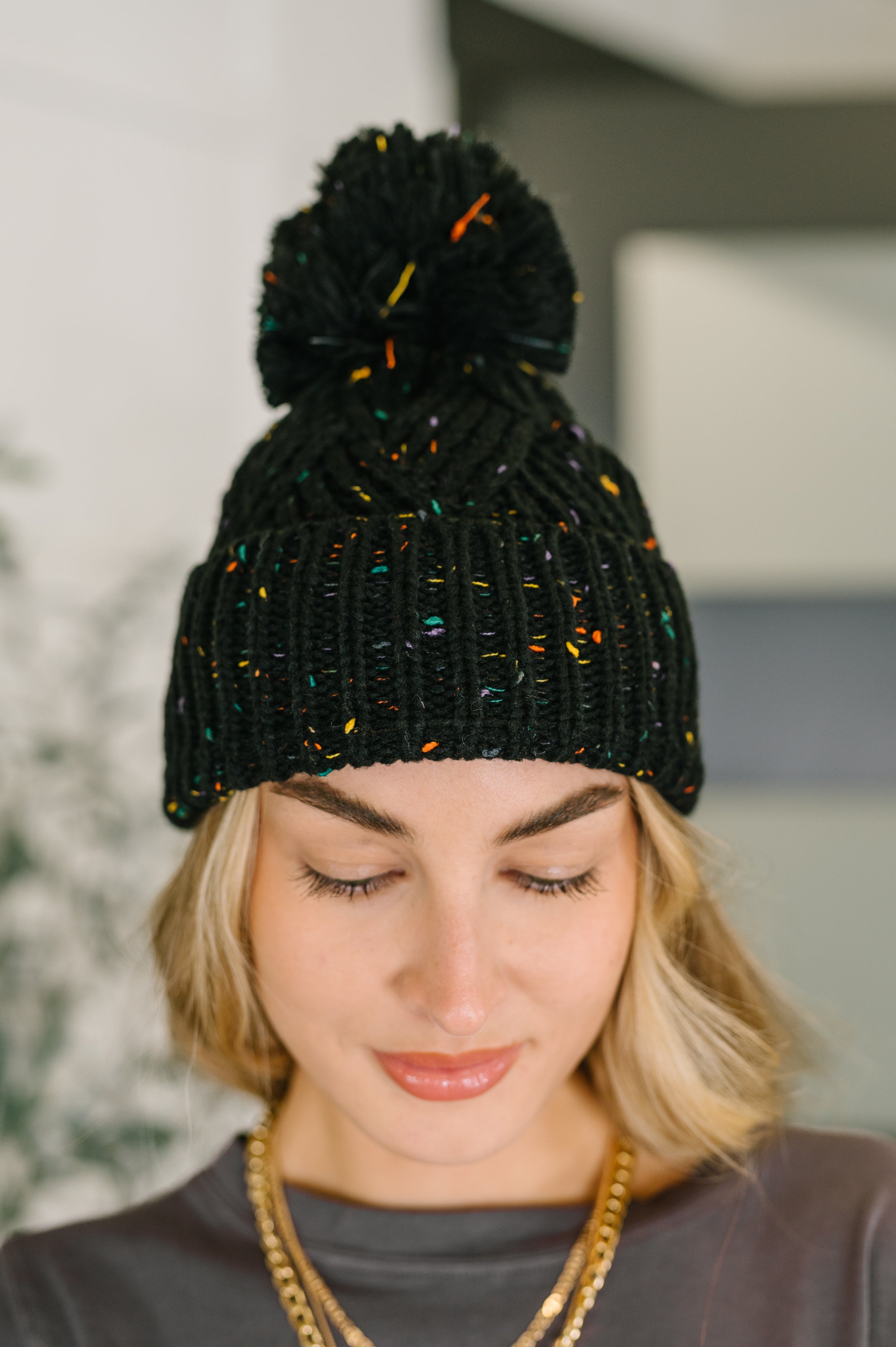 Cover Your Ears Pom Pom Beanie in Black - Charming Charlie