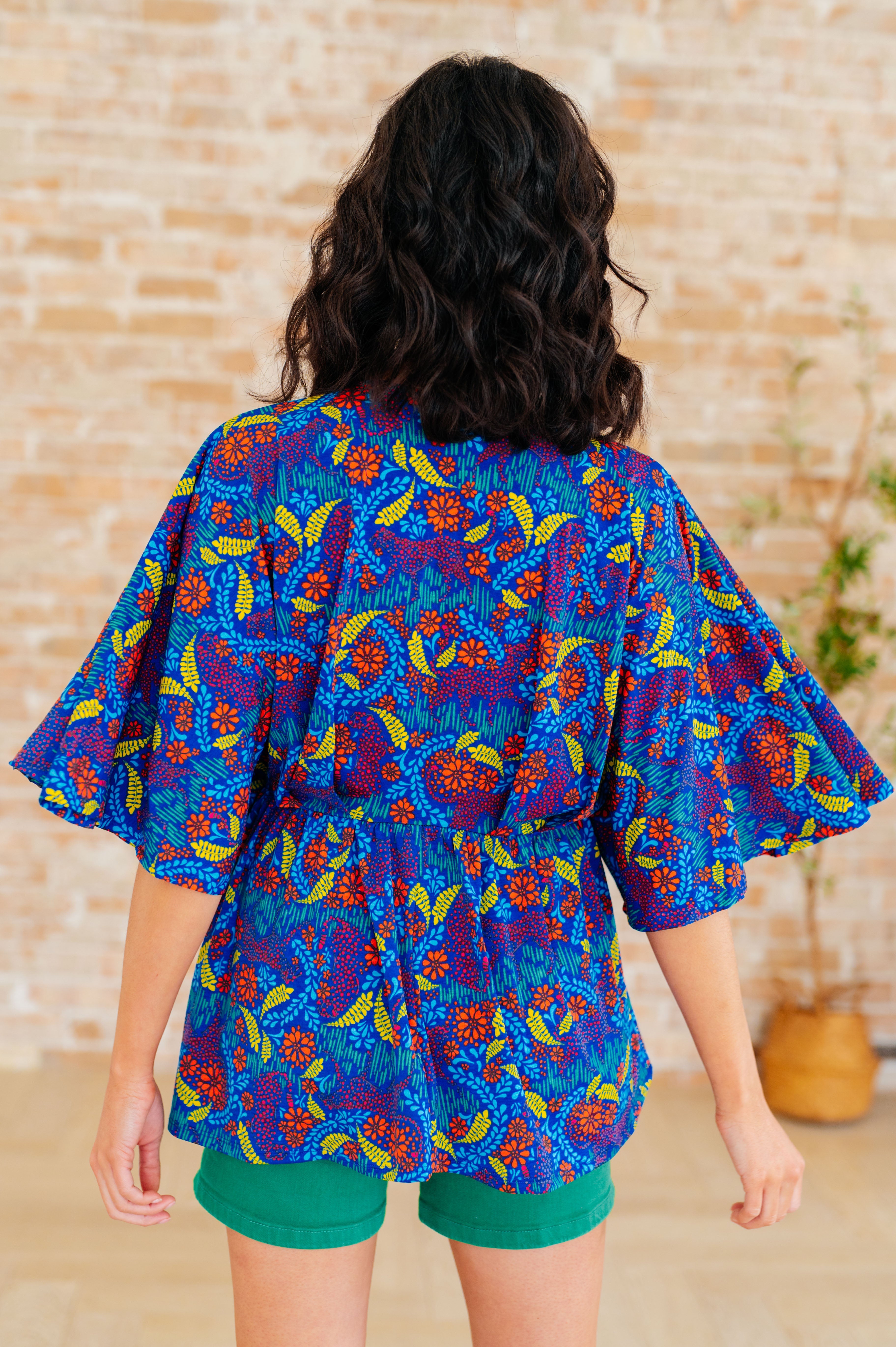 Dreamer Peplum Top in Royal and Red Abstract - Charming Charlie