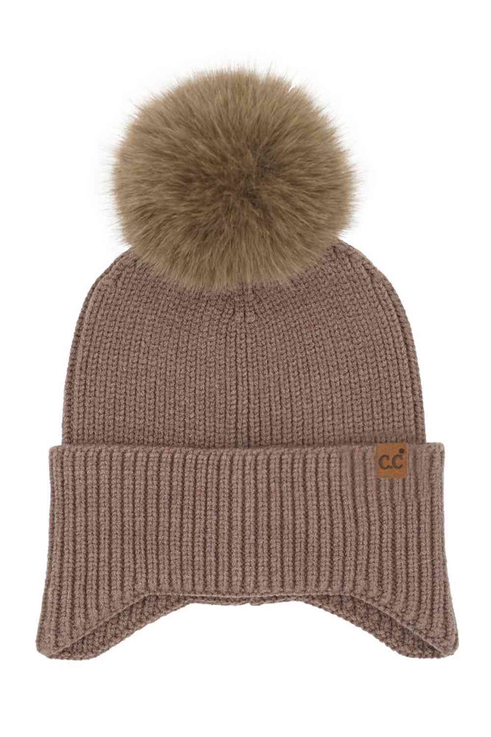 Mocha Stay cozy and chic with our C.C Earflap Pom Knit Solid Beanie! This adorable beanie features ear flaps and a playful pom-pom, adding a touch of fun to your winter wardrobe. Whether you're hitting the slopes or strolling in the city, this beanie is a must-have accessory. Perfect for gifting or treating yourself—elevate your look with this stylish beanie today!