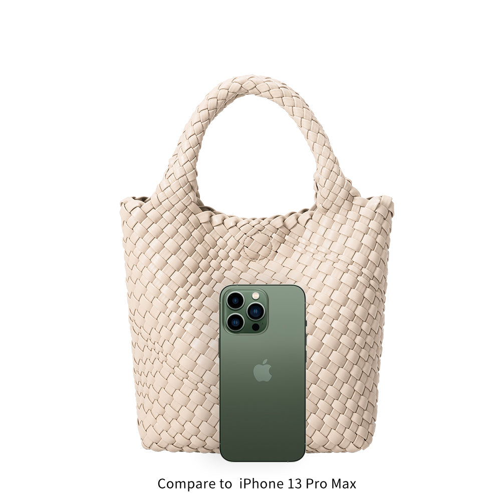 An iphone 13 pro size comparison for a small woven vegan leather tote bag with double handle.