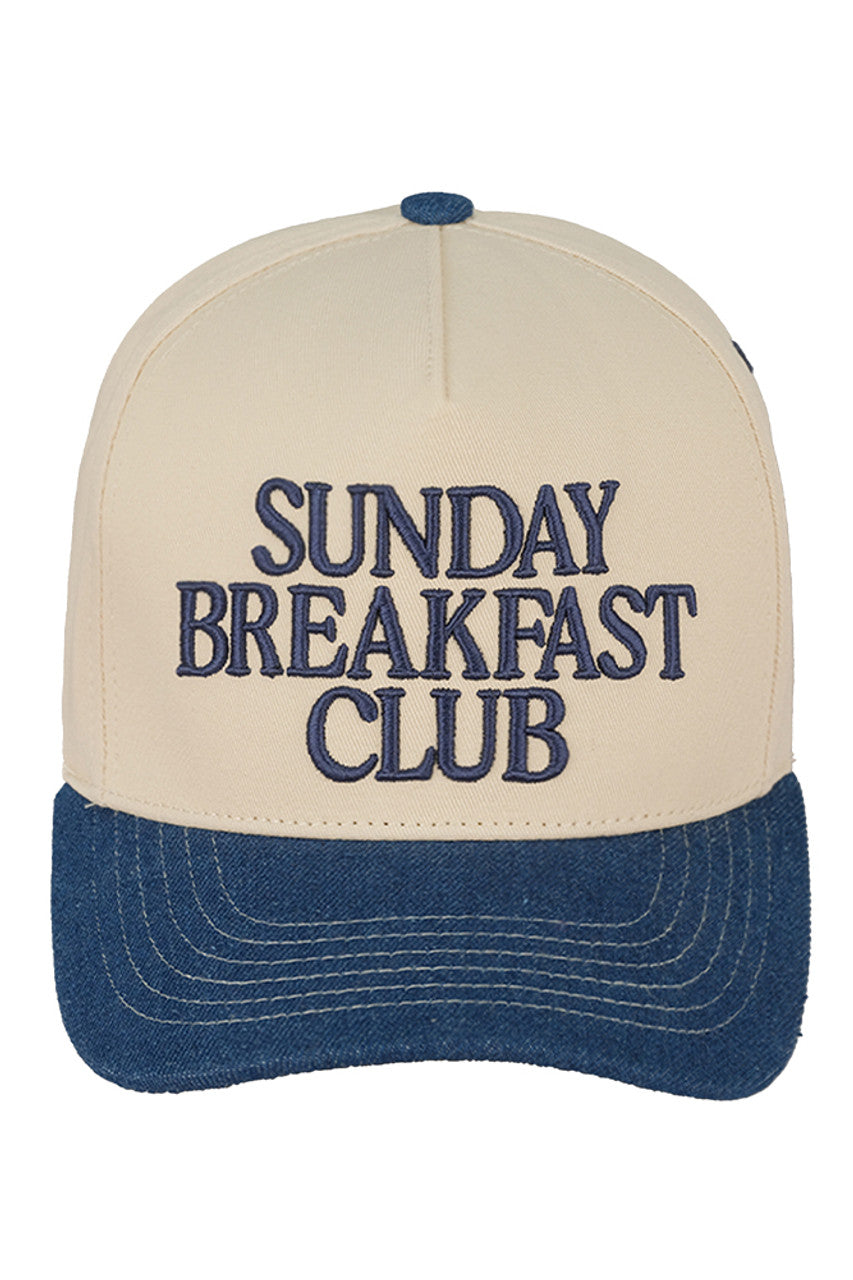 Dark Denim C.C SUNDAY BREAKFAST CLUB Embroidered Trucker Cap combines classic trucker style with detailed embroidery for a refined casual look. Its breathable mesh back ensures comfort during extended wear, while the adjustable snap closure provides a customizable fit. Perfect for everyday use, this cap combines style and practicality for those who appreciate high-quality headwear.
