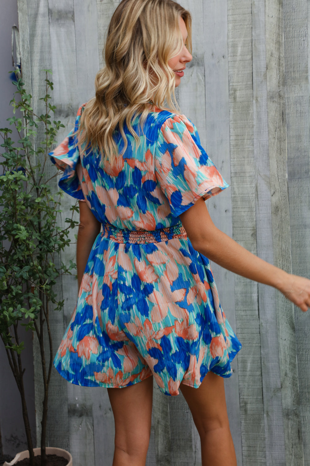 Feeling Bold Turquoise Floral Smocked Waist Flutter Sleeve Romper - Charming Charlie