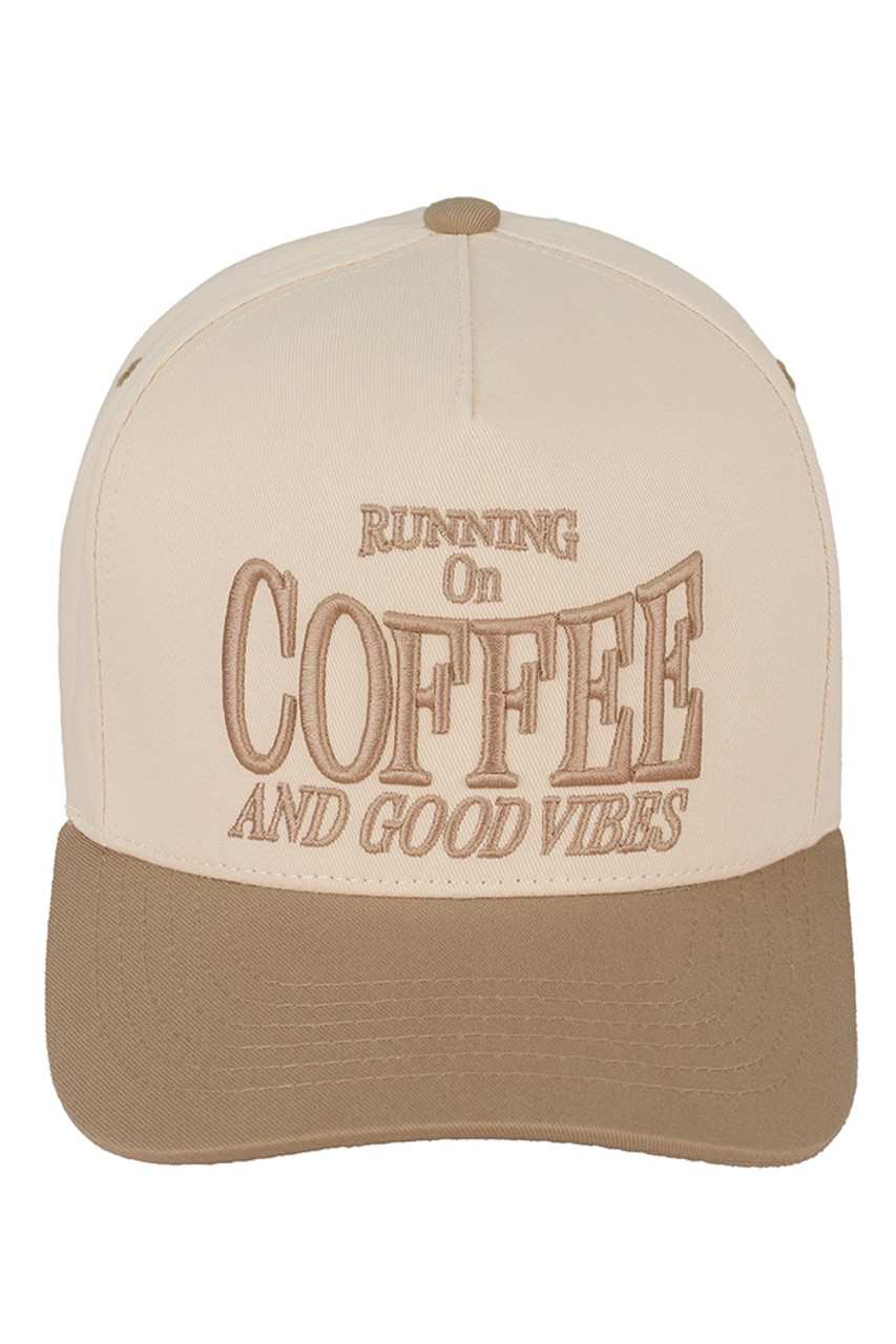 Beige C.C RUNNING ON COFFEE AND GOOD VIBES Trucker Cap is the perfect accessory for any coffee lover. Made from high-quality materials, this cap will keep you stylish and comfortable while you enjoy your favourite caffeinated beverage. With its trendy design and positive message, it's sure to bring good vibes wherever you go.