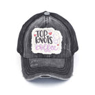 Black C.C DISTRESSED TOP KNOTS AND COFFEE PATCH PONYCAP is an essential accessory for coffee lovers. Made with distressed fabric and a stylish top knot, it also features an embroidered coffee patch. Stay fashionable while showing off your love for coffee.