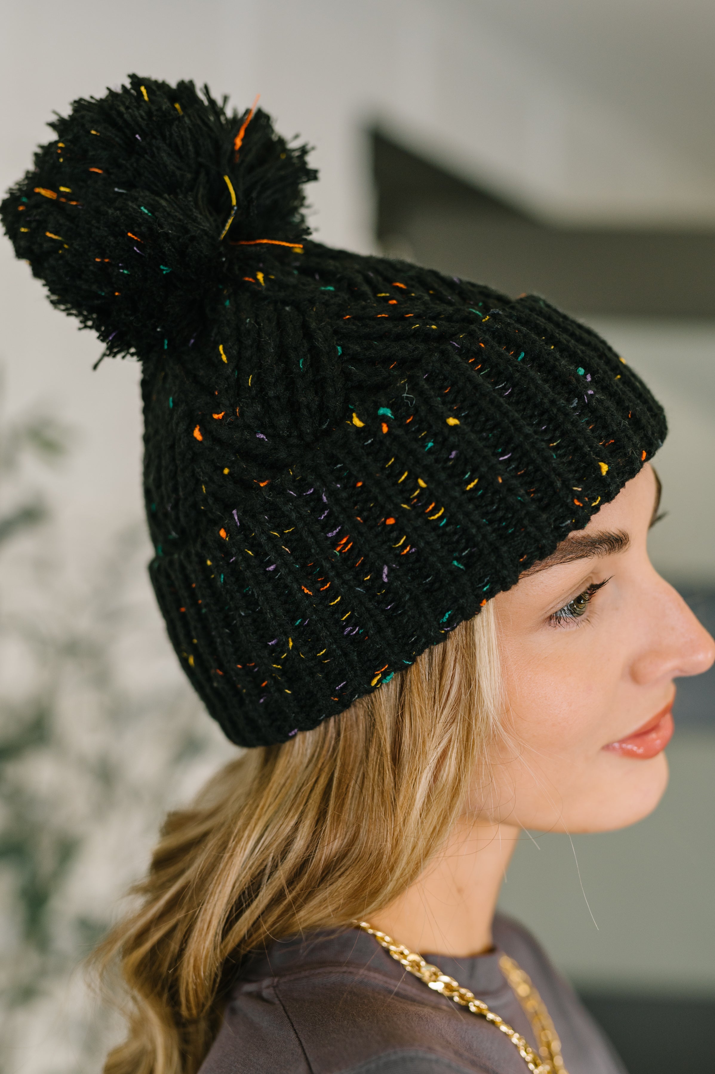 Cover Your Ears Pom Pom Beanie in Black - Charming Charlie