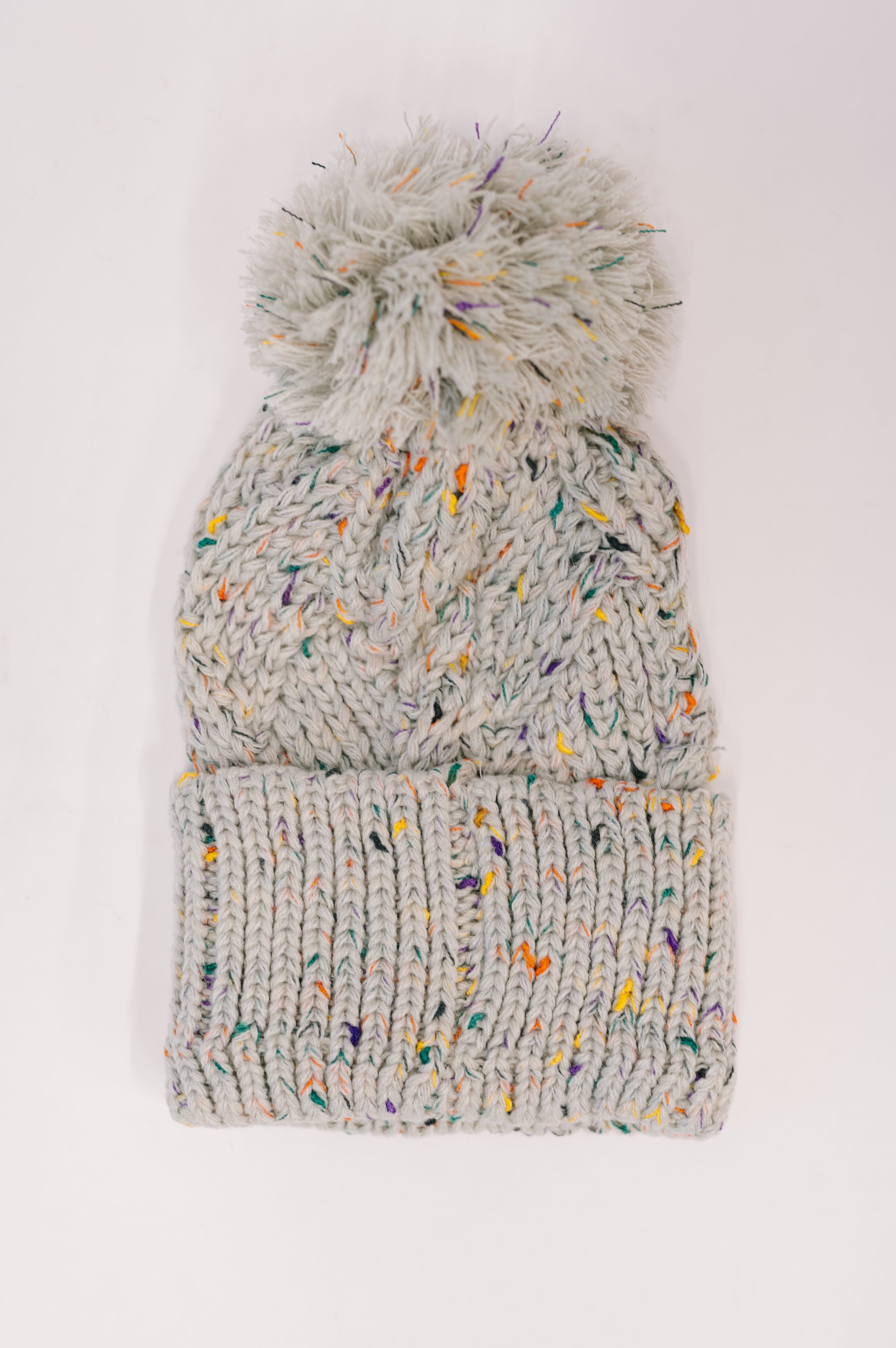 Cover Your Ears Pom Pom Beanie in Grey - Charming Charlie