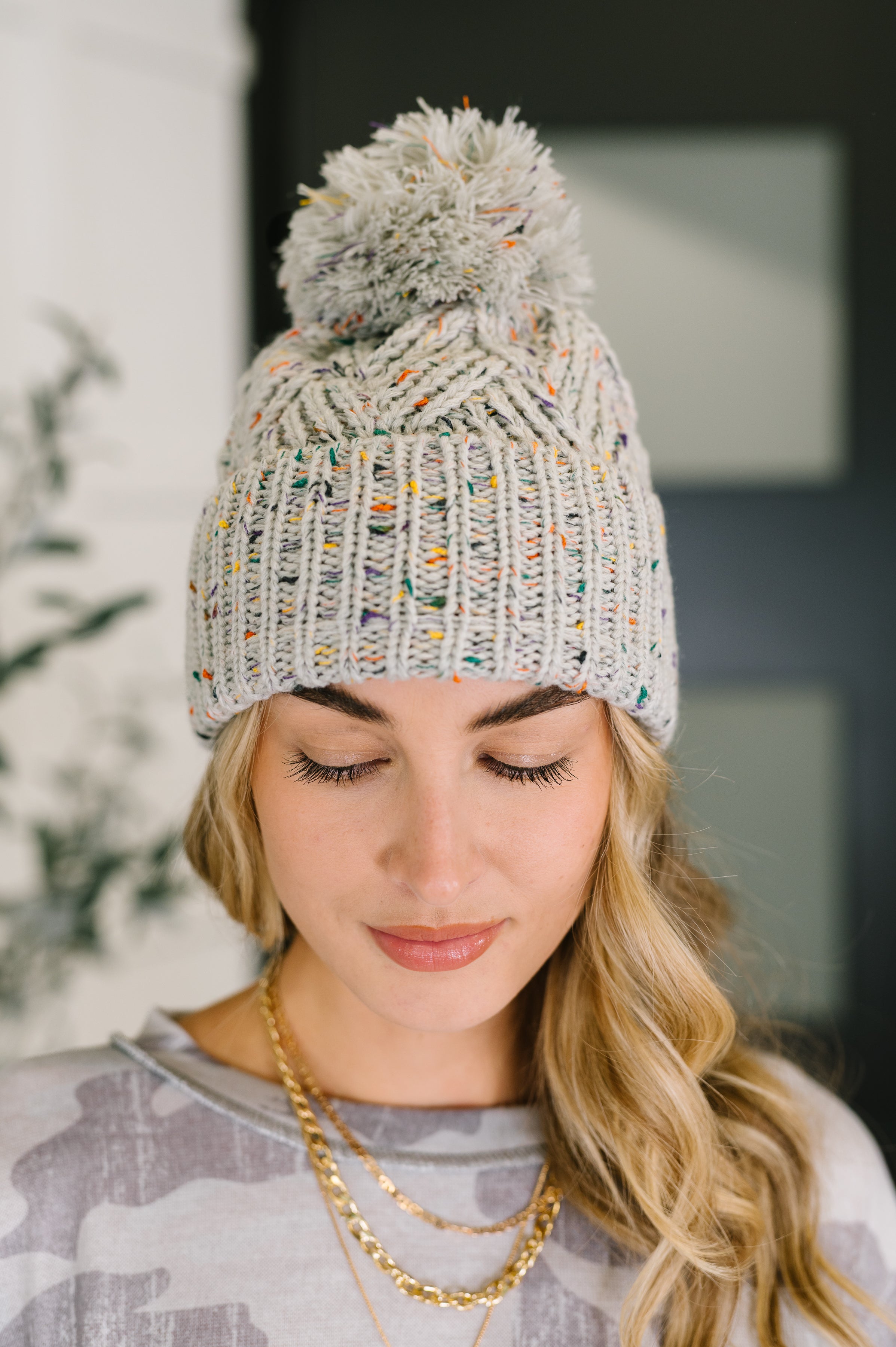 Cover Your Ears Pom Pom Beanie in Grey - Charming Charlie