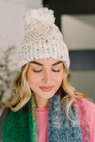 Cover Your Ears Pom Pom Beanie in Ivory - Charming Charlie