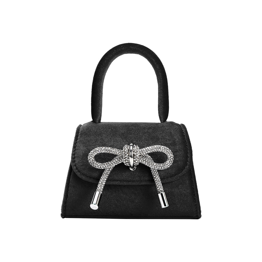 A mini black velvet top handle bag with a silver encrusted bow.