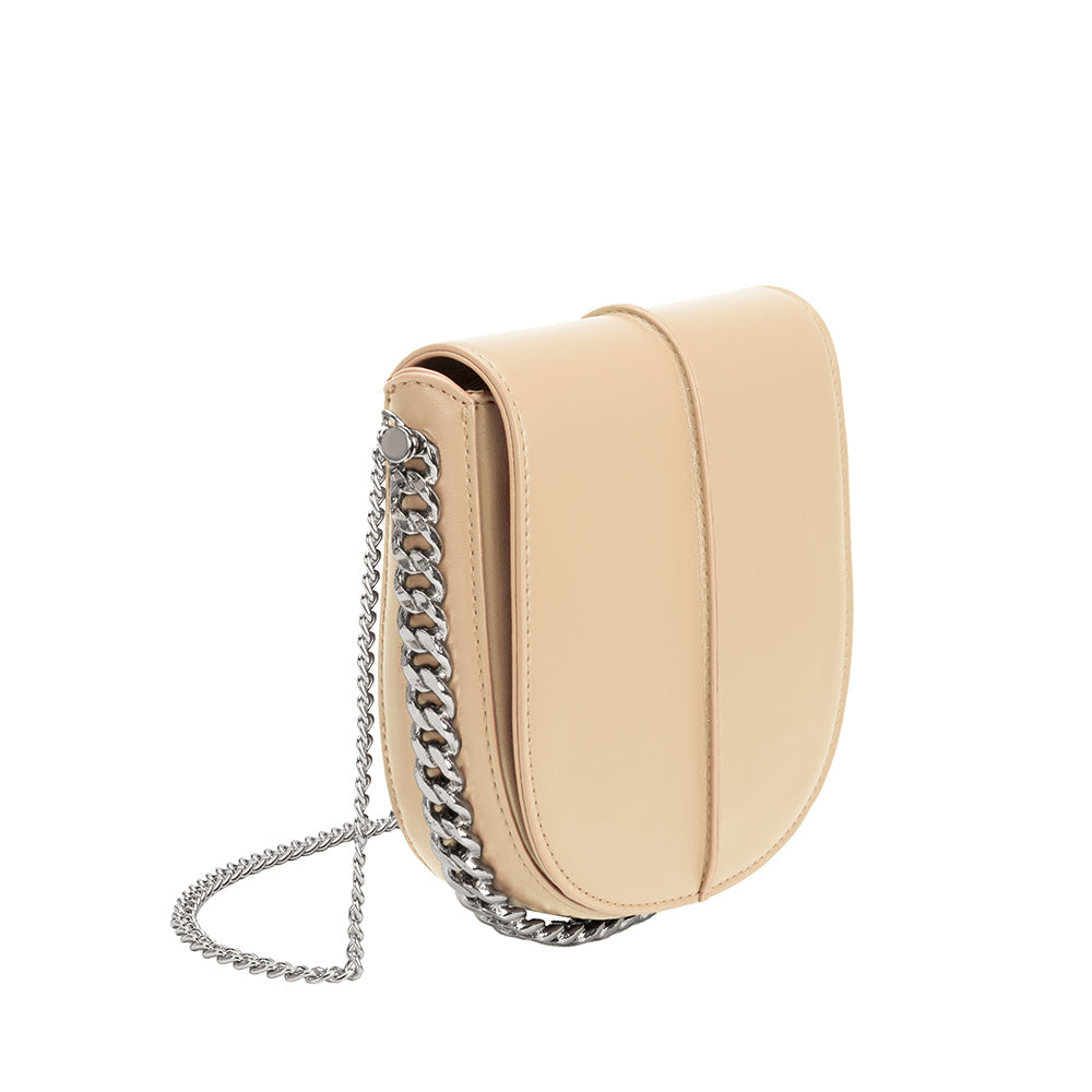 A nude vegan leather crossbody handbag with silver handle.