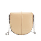 A nude vegan leather crossbody handbag with silver handle. 