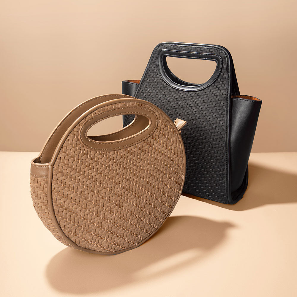 A still image of a square and circle woven recycled vegan leather top handle bag. 