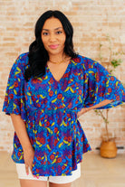 Dreamer Peplum Top in Royal and Red Abstract - Charming Charlie