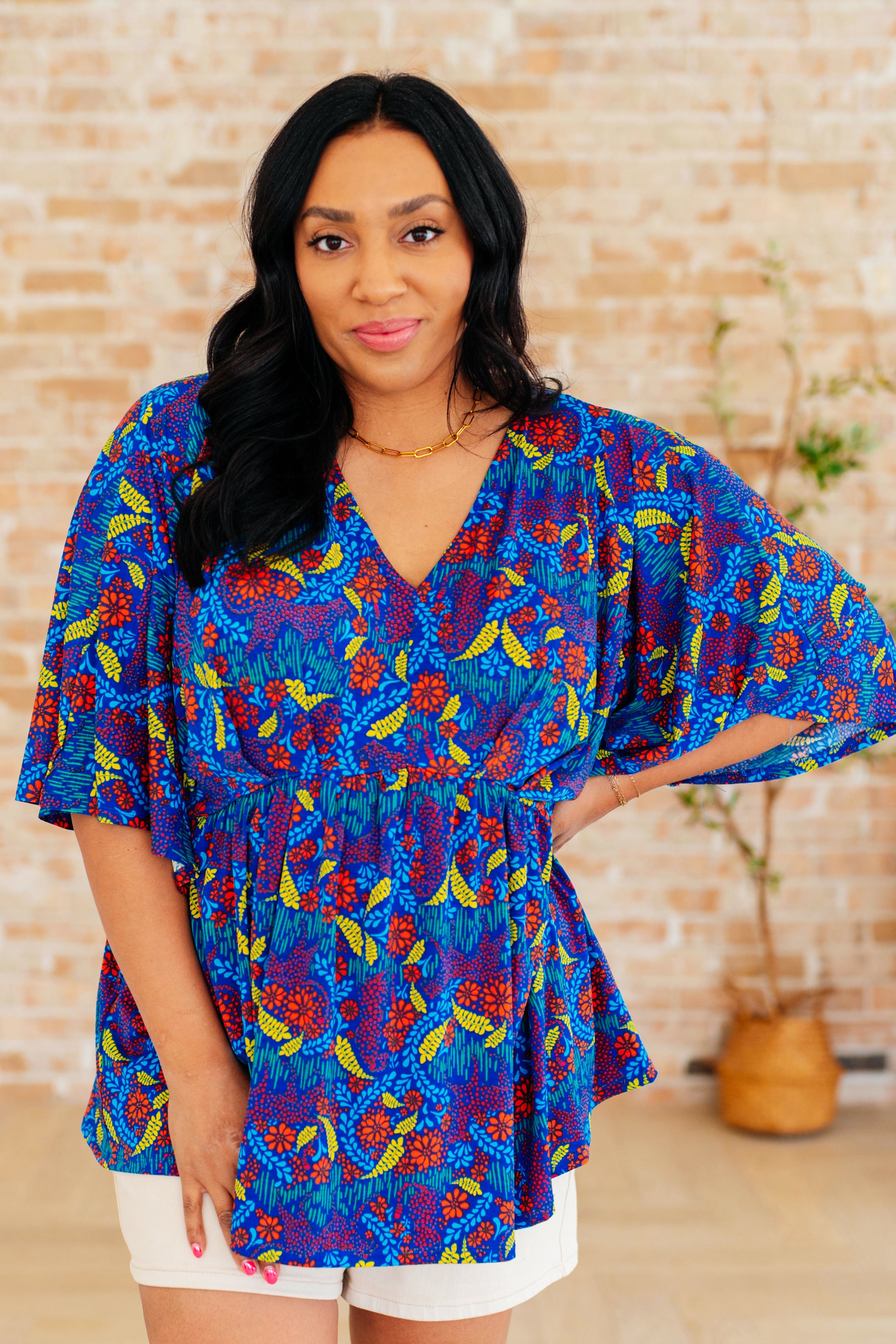 Dreamer Peplum Top in Royal and Red Abstract - Charming Charlie