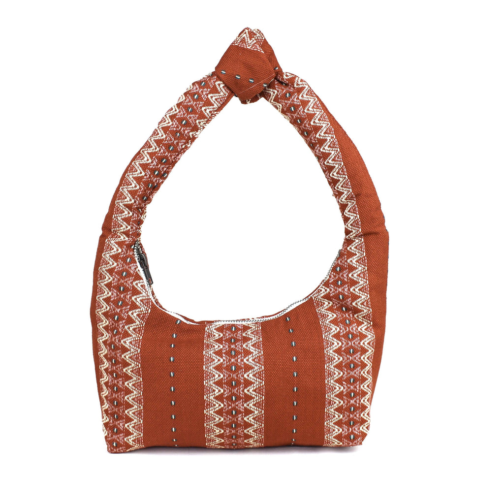 Artisan Aurora Handwoven Ginger Shoulder Bag. The pattern has white vertical zig zag stripes over a brown background.