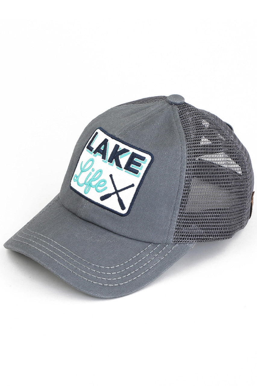 Gray C.C LAKE LIFE PATCH CRISS CROSS PONY CAP is the perfect accessory for those who love spending time at the lake. The crisscross pony cap design adds a stylish touch, while the lakelife patch showcases your love for the great outdoors. Made with high-quality materials, this cap provides both comfort and durability.