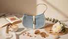 Denim Shoulder Bag with Cream Leather Trim and Buckle Accent - Charming Charlie