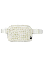 Ivory C.C Quilted Puffer Fanny Pack is a stylish and functional accessory for any on-the-go individual. Made with durable quilted material, this fanny pack provides convenient storage for your essentials while remaining comfortable to wear. Perfect for travelers, runners, and outdoor enthusiasts.