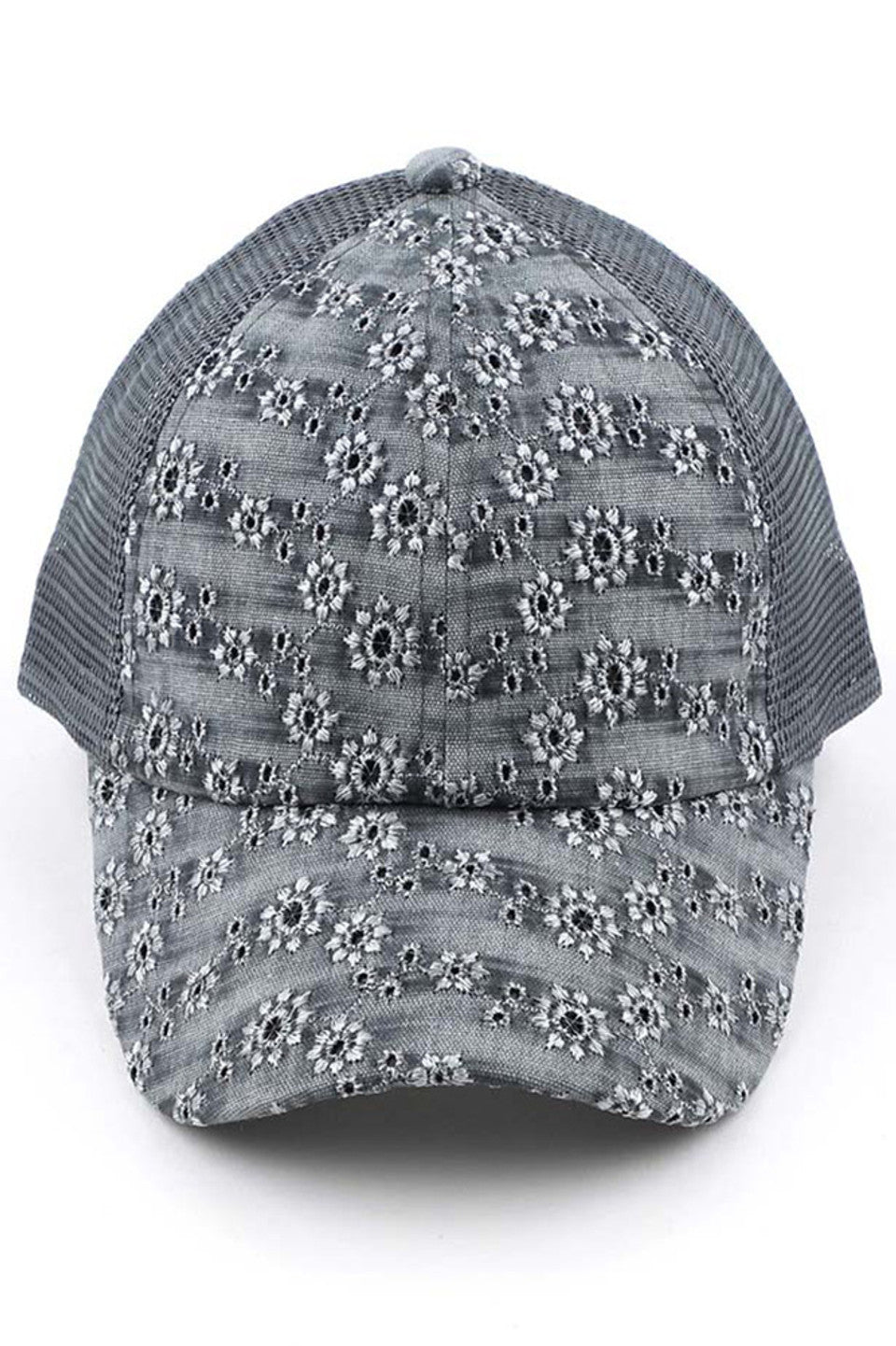 Light gray C.C FLOWER EMBROIDERY EYELET CRISS CROSS PONYCAP features delicate flower embroidery and eyelet detailing, with a criss cross design for a chic and stylish look. Made with quality materials, this cap offers both fashion and functionality. Perfect for any casual or outdoor activity, it will keep you cool and covered.