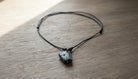 Black Cord Necklace with a Bone Pendant - Charming Charlie