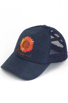 Navy C.C DAISY PATCH BLESSED PONY CAP is the perfect accessory for any ponytail! With the bonus of a daisy patch, this cap not only keeps you in style but also adds a touch of femininity to your look. Keep your hair out of your face and elevate your outfit with this cap.
