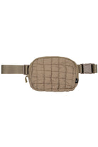 Taupe C.C Quilted Puffer Fanny Pack is a stylish and functional accessory for any on-the-go individual. Made with durable quilted material, this fanny pack provides convenient storage for your essentials while remaining comfortable to wear. Perfect for travelers, runners, and outdoor enthusiasts.