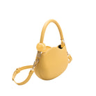 A small yellow structured vegan leather crossbody bag with a marble pearl accessory. 