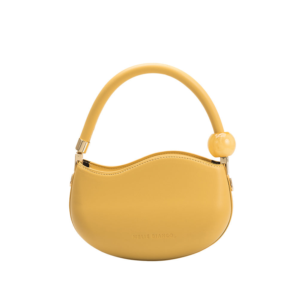 A small yellow structured vegan leather crossbody bag with a marble pearl accessory. 