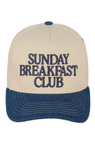 Dark Denim C.C SUNDAY BREAKFAST CLUB Embroidered Trucker Cap combines classic trucker style with detailed embroidery for a refined casual look. Its breathable mesh back ensures comfort during extended wear, while the adjustable snap closure provides a customizable fit. Perfect for everyday use, this cap combines style and practicality for those who appreciate high-quality headwear.