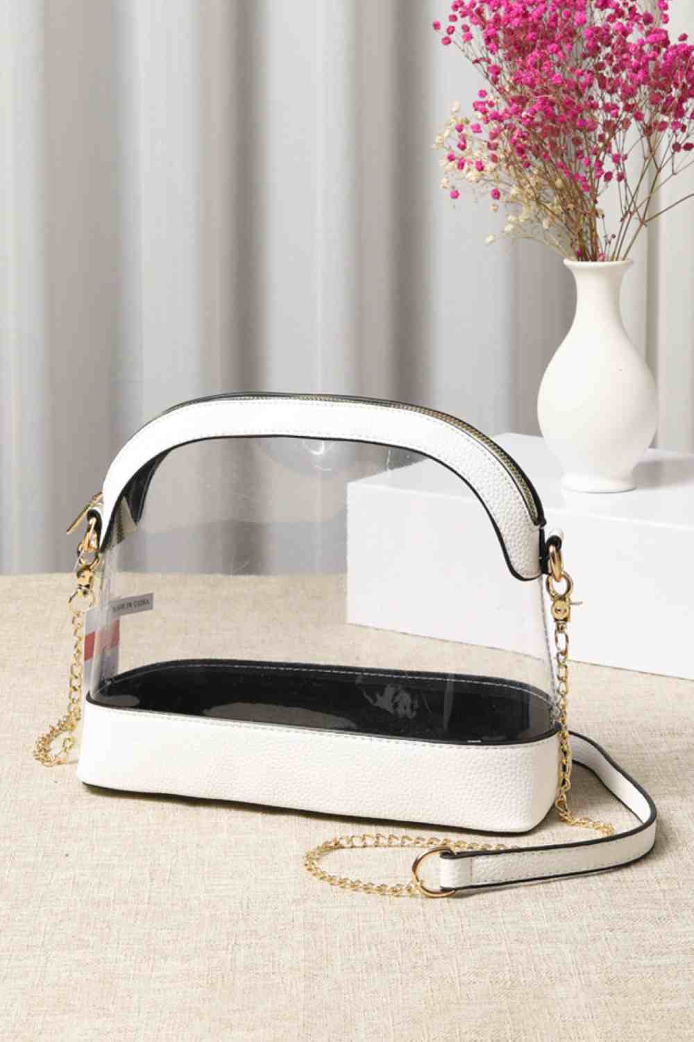 White Clear Stadium Concert Bag is expertly crafted to comply with most venue security policies, featuring a fully transparent design for easy inspection. Its durable, lightweight construction ensures convenience without bulk, while providing ample space for essentials such as tickets, phones, and wallets. Ideal for concert and sports fans, it combines security compliance with practical everyday use.