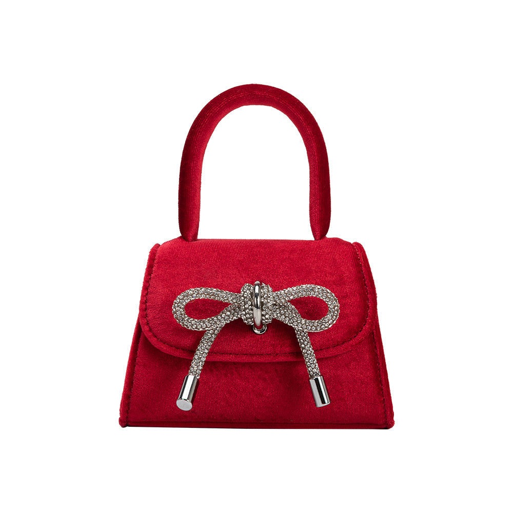 A mini red velvet top handle bag with a silver encrusted. 