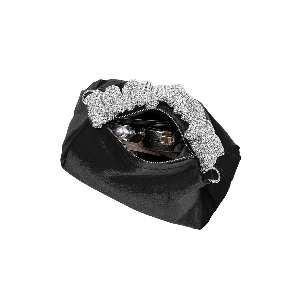 An inside view image of a medium velvet top handle bag with a silver encrusted handle. 