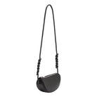 A small black crescent shaped vegan leather crossbody bag with a braided strap. 