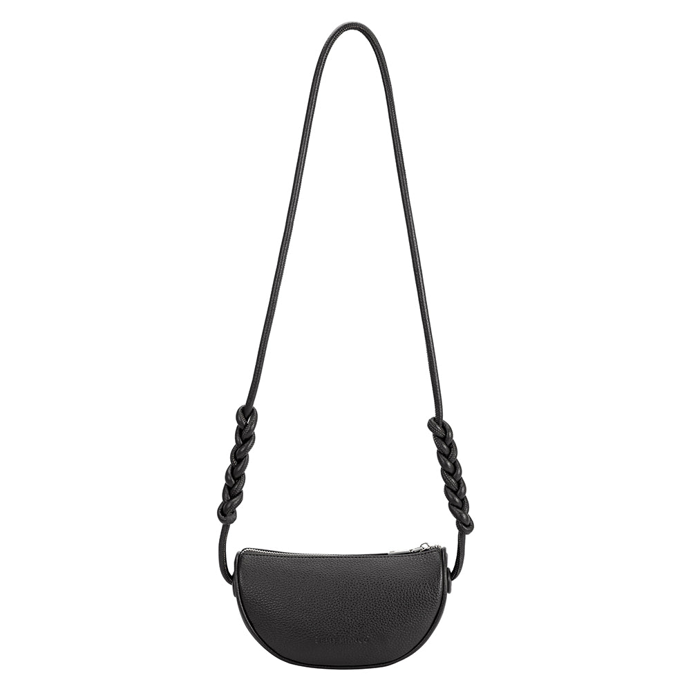 A small black crescent shaped vegan leather crossbody bag with a braided strap. 