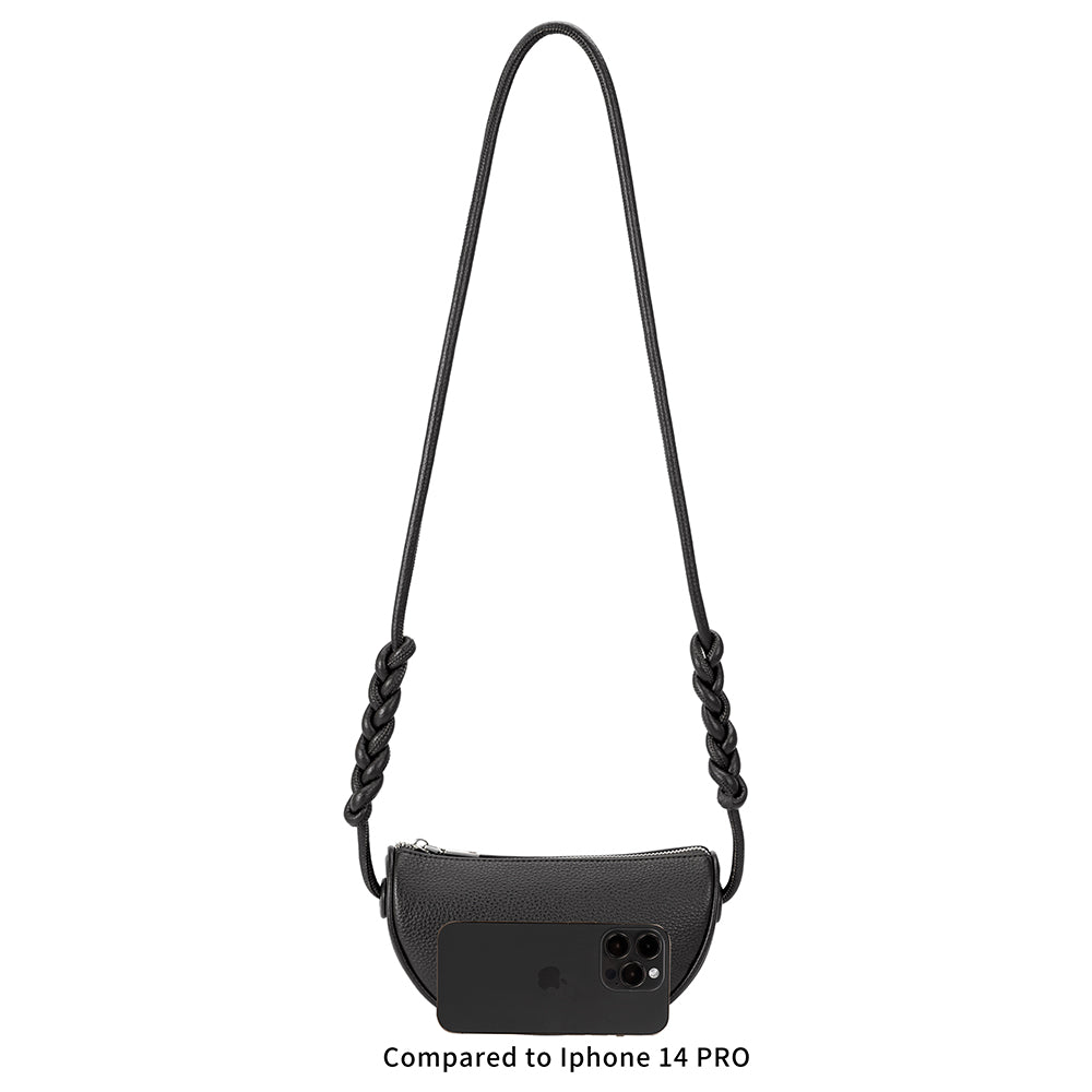 An iphone 14 pro size comparison image for a small crescent shaped crossbody bag with braided strap. 