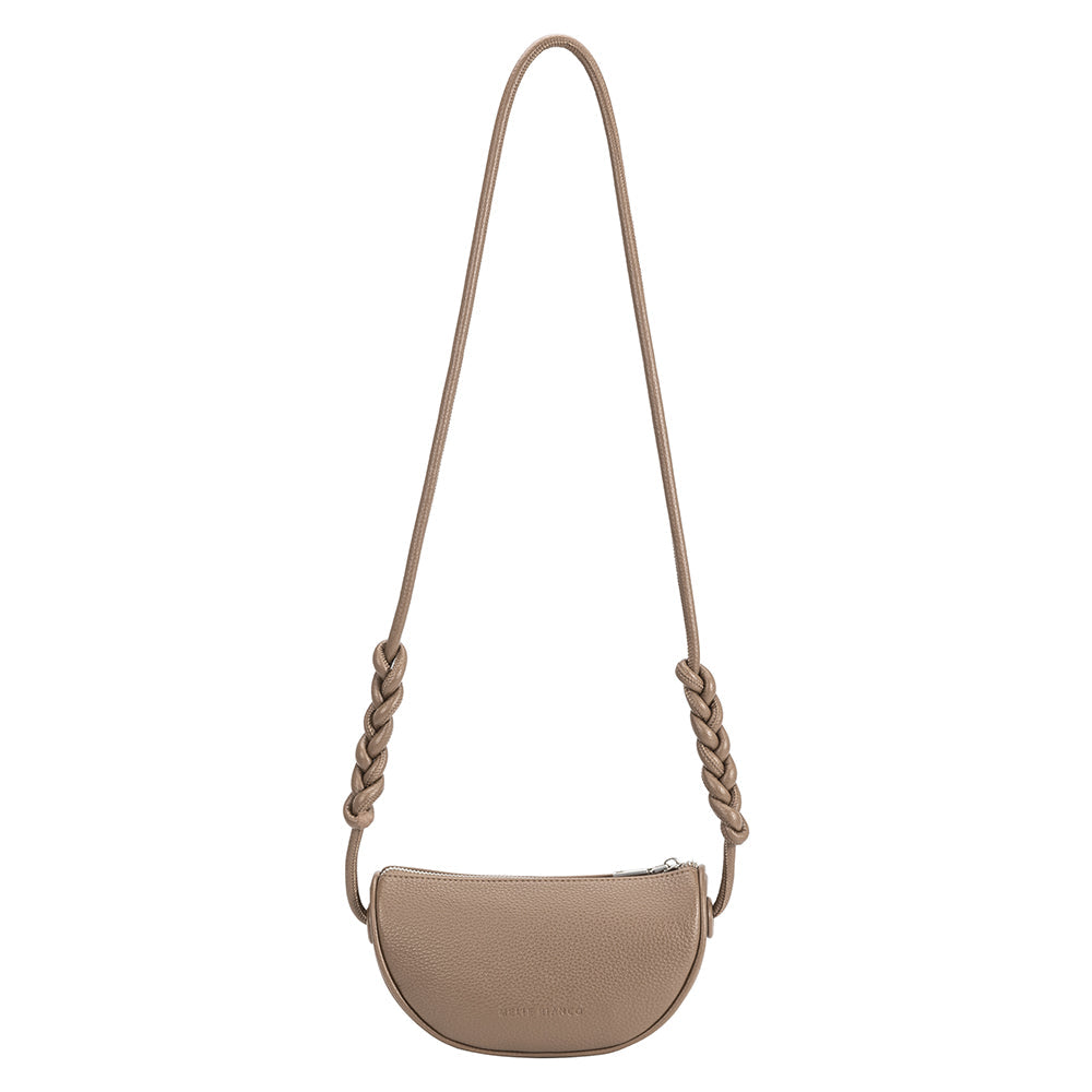 A small taupe crescent shaped vegan leather crossbody bag with a braided strap.