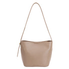 A taupe recycled vegan leather shoulder bag with adjustable strap. 