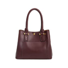 A small burgundy recycled vegan leather crossbody handbag with gold hardware. 