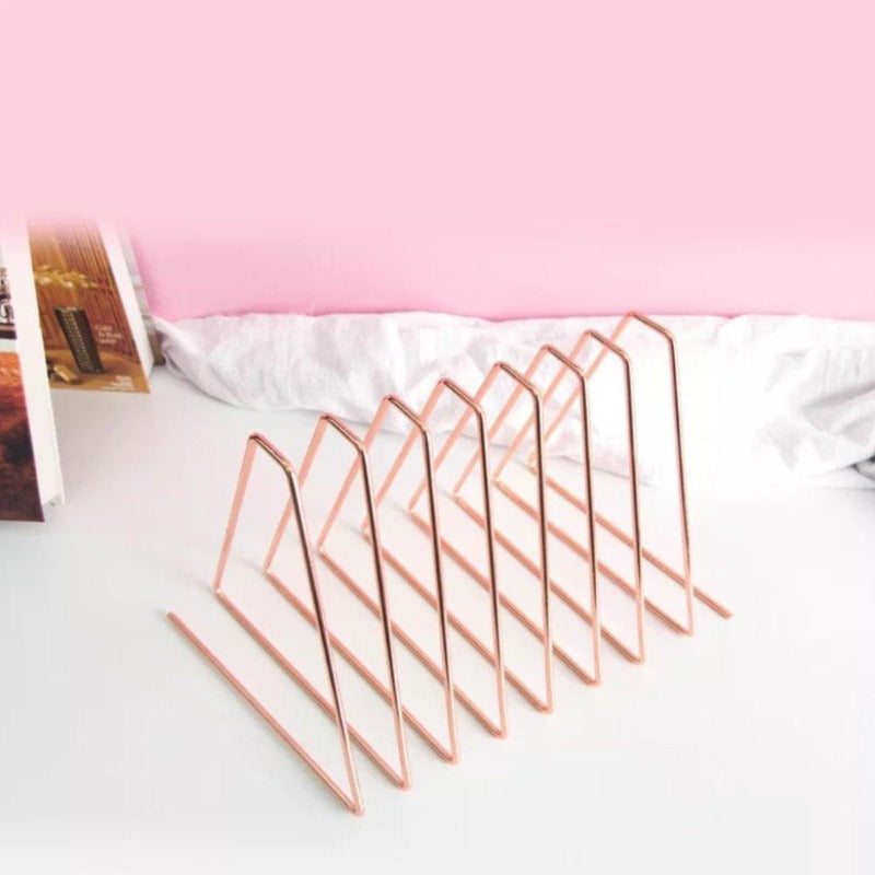 Metal file organizer in rose gold on a desk