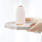 Decorative spa humidifier lamp in white on a tray