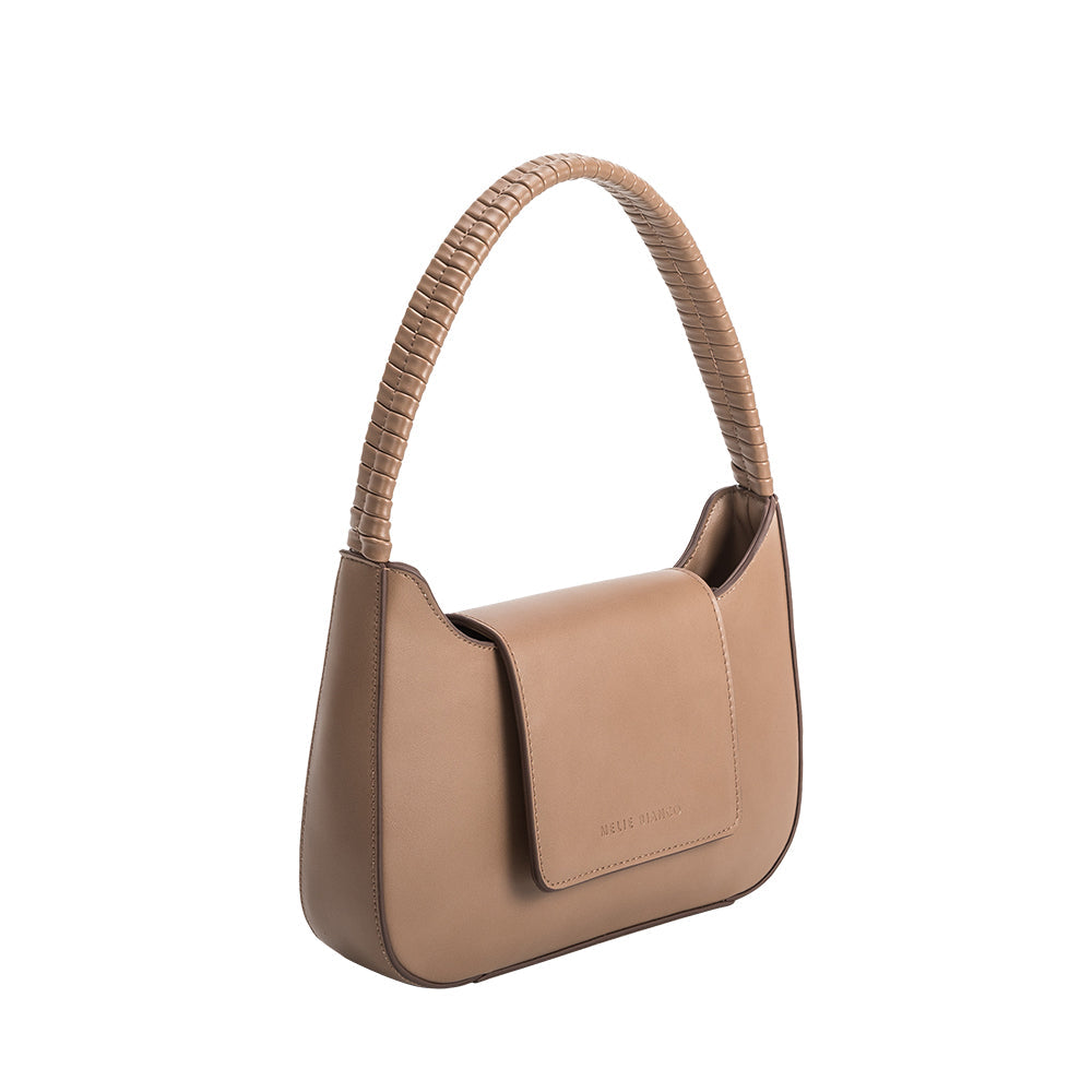 A small taupe vegan leather shoulder bag with a wrapped handle. 