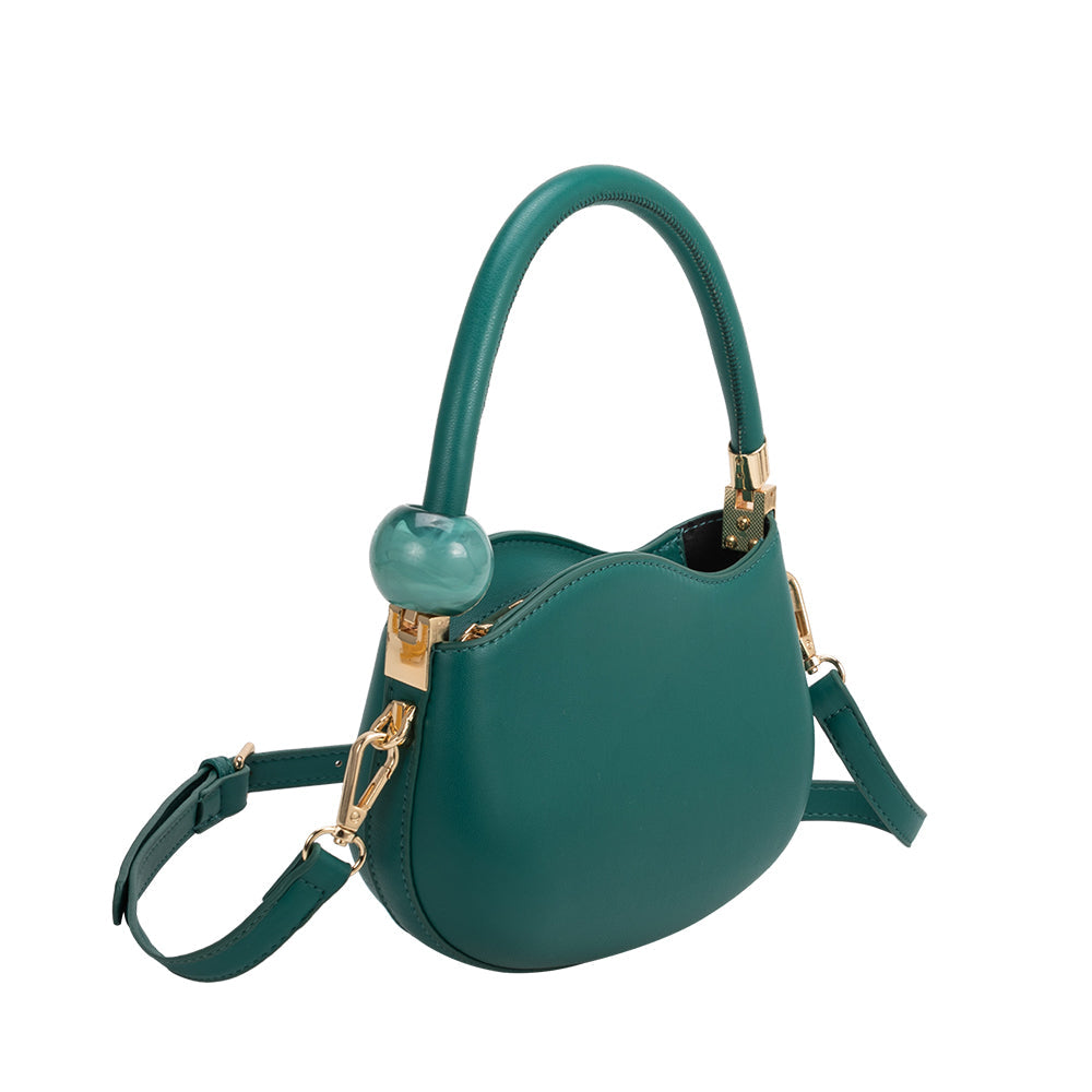 A small jade structured vegan leather crossbody bag with a marble pearl accessory.
