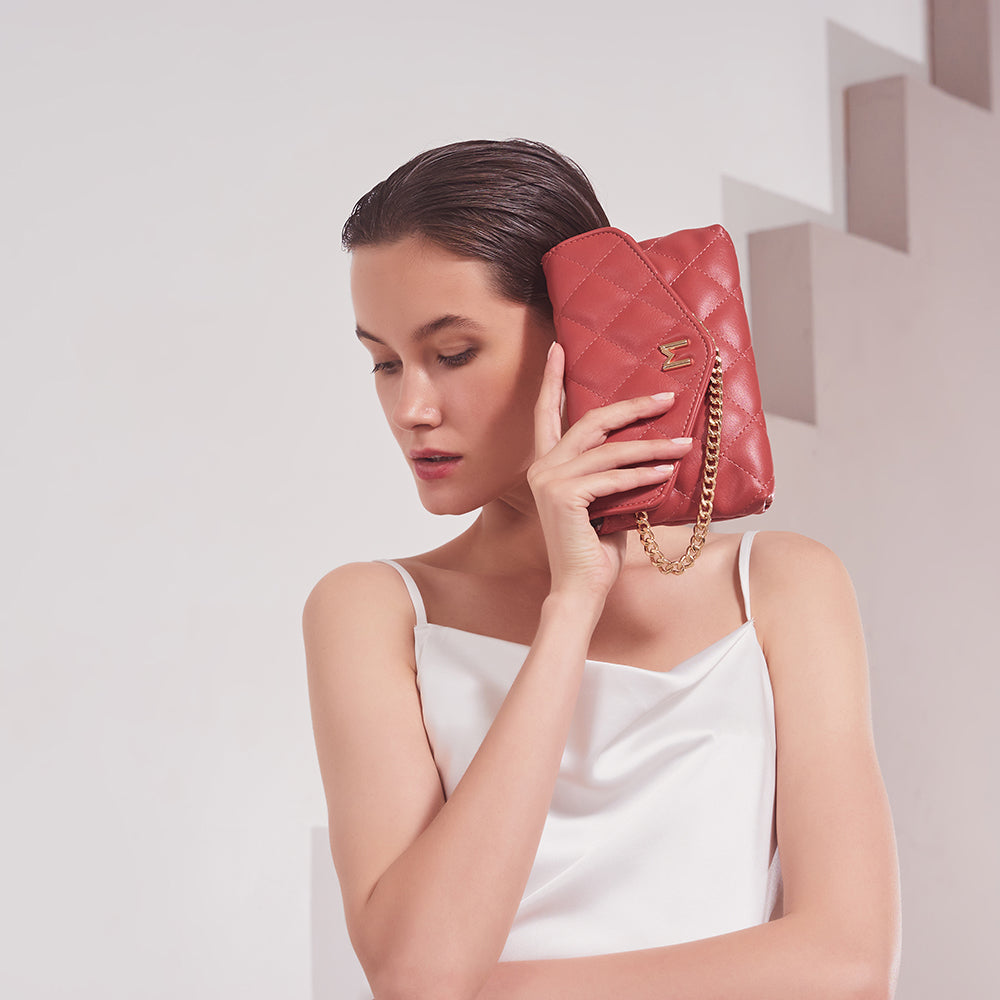 Model Wearing Melie Bianco Luxury Vegan Leather Gigi Clutch Bag in Rose with gold chain