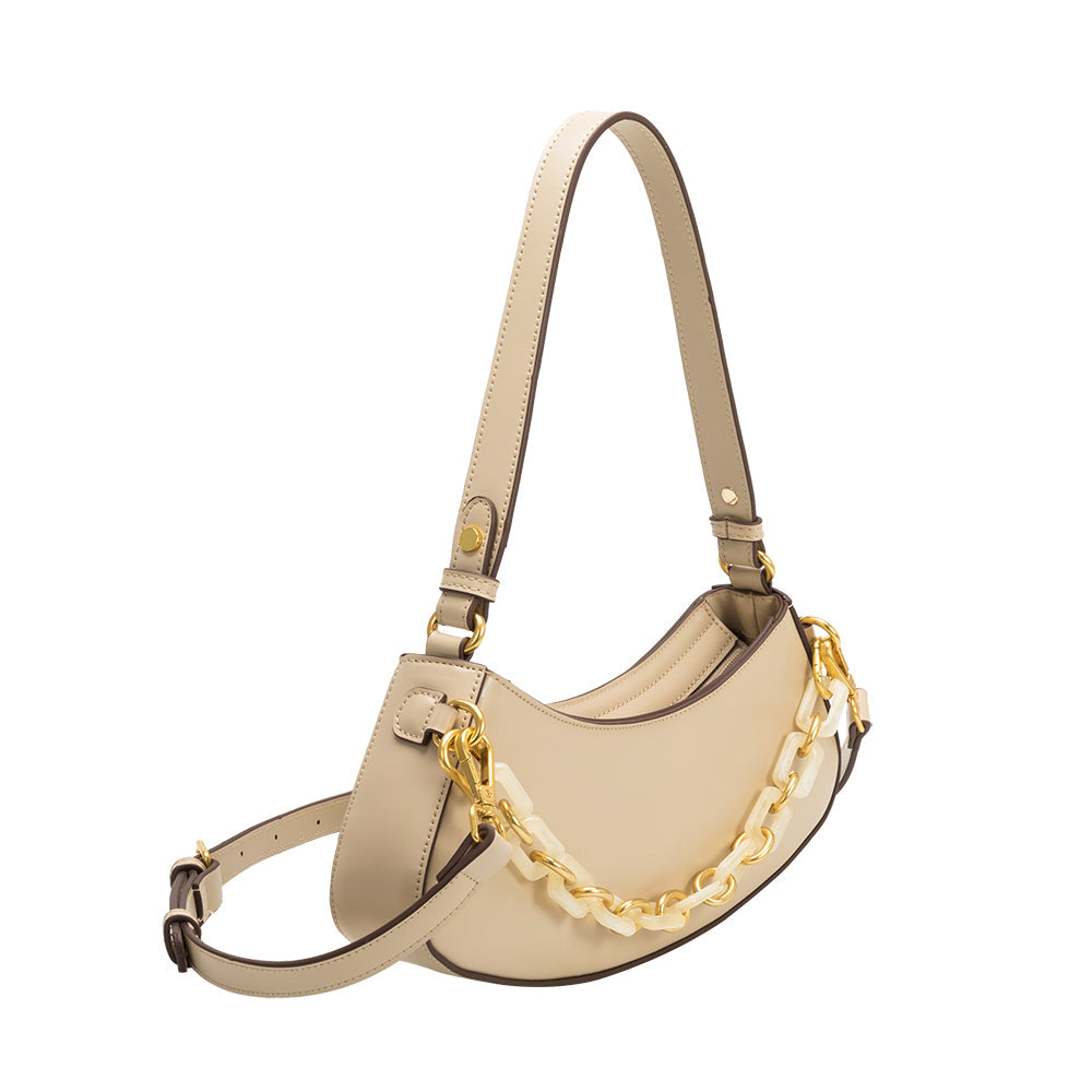 A cream recycled vegan leather shoulder bag with a chain on the front. 